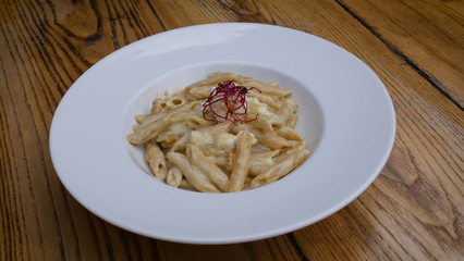A dish of the Carbonara paste with seafood in a big white plate. Pasta, cafe.