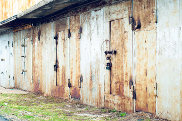 Fototapeta na wymiar Old rusty gate of car garages