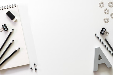 Black and white office accessories on the desk. Copy space.