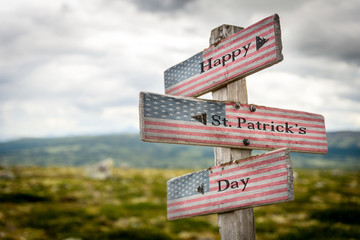 Happy st patricks day text on wooden american flag signpost outdoors in nature.