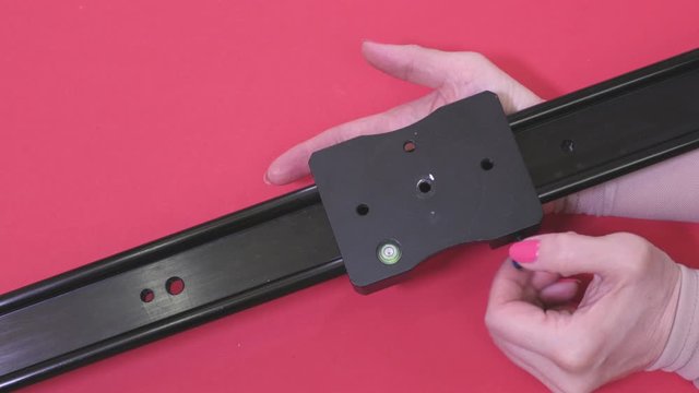 Woman Examining Video Slider On Red