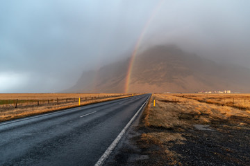 A rainbow and golden light after a winter storm in south Iceland