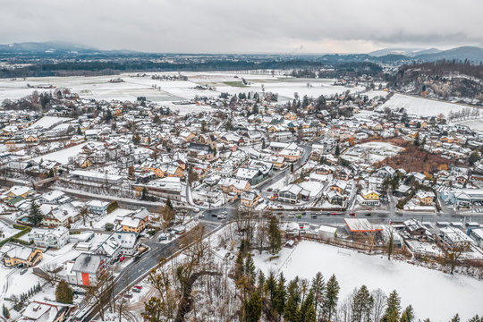 Aerial view of Austrian Alps valley village near Salzburg outskirts in winter during heavy snow time