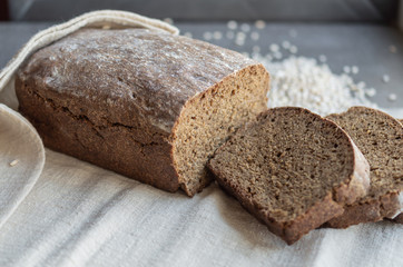 homemade black rye bread is cut into pieces on a light linen napkin