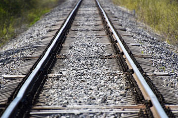 Obraz premium Between rails of a railroad in the forest with concrete sleepers.