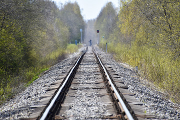 Hot summer day railroad long shot with a man figure standing in the middle. 