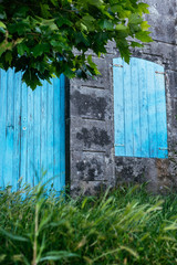 Blue door and window on a stone wall