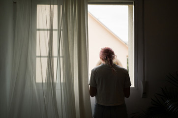 Girl next to the window of her bedroom