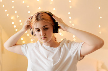 Girl listening music and dancing in her bedroom