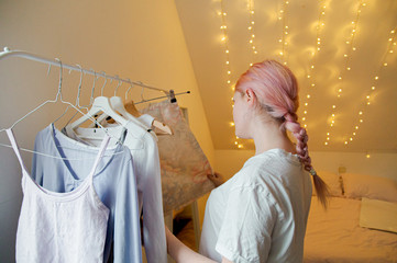 Girl trying on clothes in her bedroom