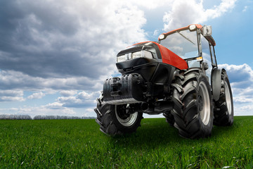 Red tractor on a agricultural field