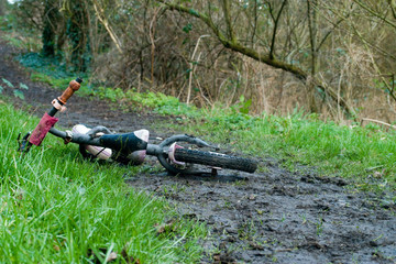 Child's bike found abandoned on muddy pathway wide shot