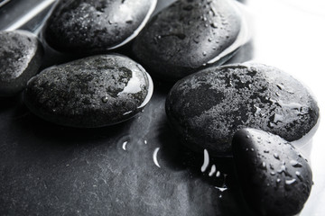 Stones in water on dark background, closeup. Zen lifestyle