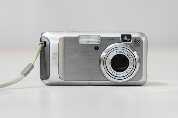 Old camera on a light background. Close-up camera. Front view.