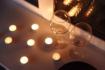 Seasonal Romantic Candle Table Centerpiece, Focused Through a Glass of Wine