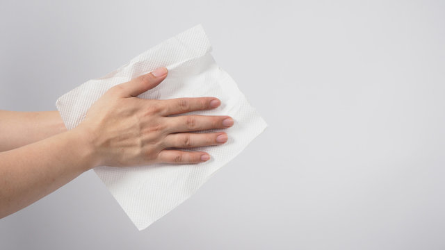 Male model is dry hands thoroughly with tissue paper on white background.