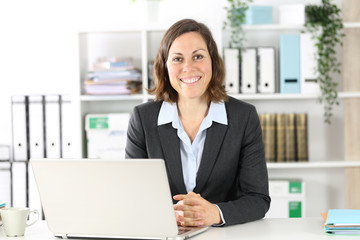 Happy adult executive posing looking at camera at office