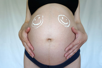 two twin smiles on a pregnant belly