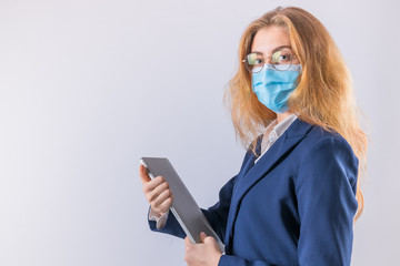 Beautiful modern business woman technology theme in protective medical mask holding tablet computer hands on white isolate background.