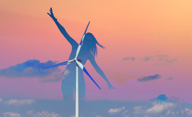 Silhouette of woman enjoying time in nature and wind power generation. Environmental issues concept - renewable energy