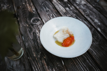 photo of Cod tomato plate on a wooden table