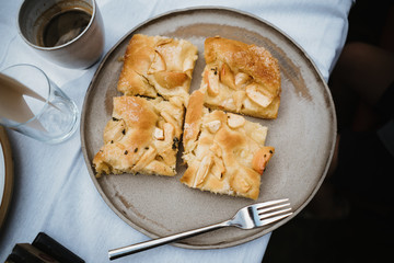 photo of an apple pie pieces in a plate with a fork