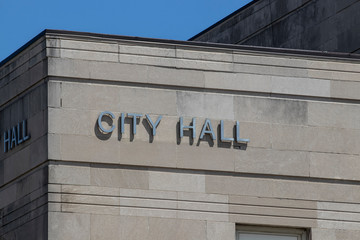 City Hall in silver text set against limestone bricks.
