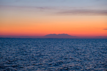 Obraz premium Colorful orange sunset over a island 