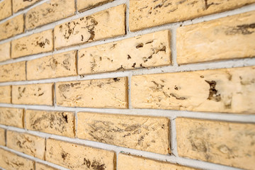 Yellow brick wall closeup. Abstract background.