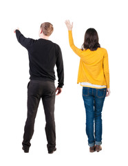 Fototapeta premium Back view of couple in sweater pointing.