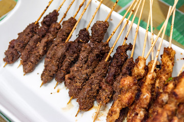 Chicken and beef skewers or meat on the grill Indonesian food satay