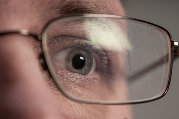 Close up of an eye ball with glasses