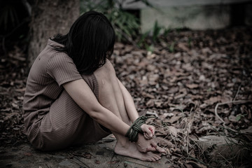 Asian hostage woman Bound with rope at night scene,The thieves kidnapped for ransom,thailand people