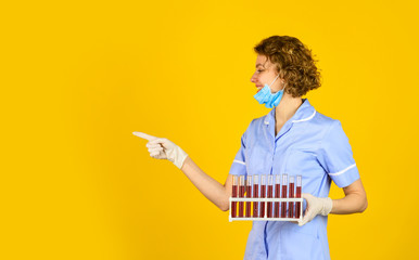 Medical worker testing tubes vaccination. Blood samples. Medical professional developing vaccine. Coronavirus treatment. Creating vaccine. Doctor respirator mask. Infection vaccine and blood test