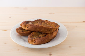 Plate  with three Torrijas Spanish french toast  isolated on white background