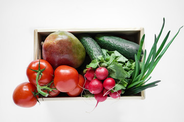 delivery of fresh vegetables and fruit in a wooden box, isolated on a white background, top view