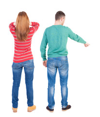 Back view of couple in sweater pointing.