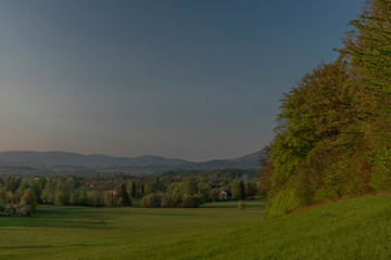 Color sunset with fresh meadows and old buidlings near Trojanovice village
