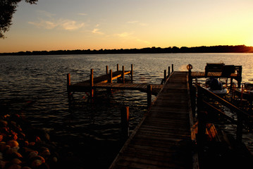 up north lake house dock on water during sunset