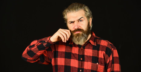 Fototapeta premium Cool man. Well groomed hipster. Barbershop concept. Facial hair care. Mature man bearded hipster with long dyed beard and mustache. Styling mustache. Growing long mustache. Moustache style