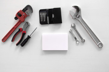 Male tools. Happy Father's Day inscription with screwdriver, Mechanic hand hold spanner tool,  presents. white card with the ability to insert text, copyspace, congratulation birthday for man, flatlay