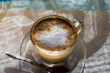 White coffee cappuccino in morning sun, Morocco 
