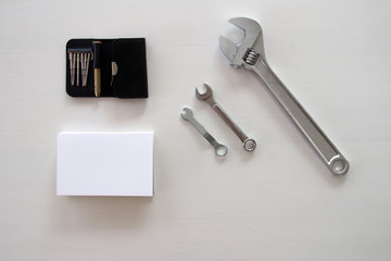 Male tools. Happy Father's Day inscription with screwdriver, Mechanic hand hold spanner tool,  presents. white card with the ability to insert text, copyspace, congratulation birthday for man, flatlay