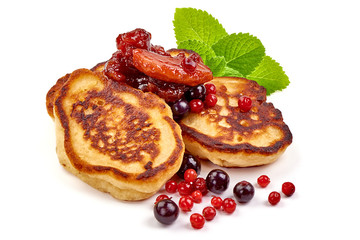 Pancakes with berries and mint, poffertjes, traditional Dutch cuisine, isolated on white background