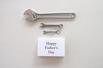 Happy Father's Day inscription with on white background. Greetings and presents. white card with the, copyspace, congratulation birthday for man, flatlay