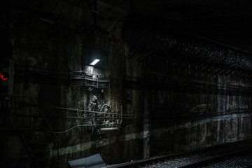 Empty underground train tunnel. Dark close-up subway station.