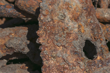 Ecology and recycling. Rusty scrap metal in a landfill in natural light. Details of cars, mechanisms.