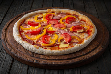 Tasty hot italian pizza with ham, tomato and sweet pepper. Pizzeria menu. Concept poster for Restaurants or pizzerias