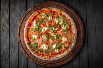 Tasty hot italian pizza Royal Prosciutto with Ham, Mushrooms, Cheddar Cheese, Oregano on old wooden table. Pizzeria menu. Concept poster for Restaurants or pizzerias