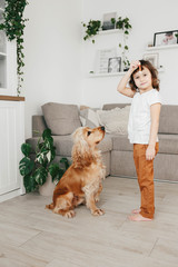 Cute little girl with dog at home